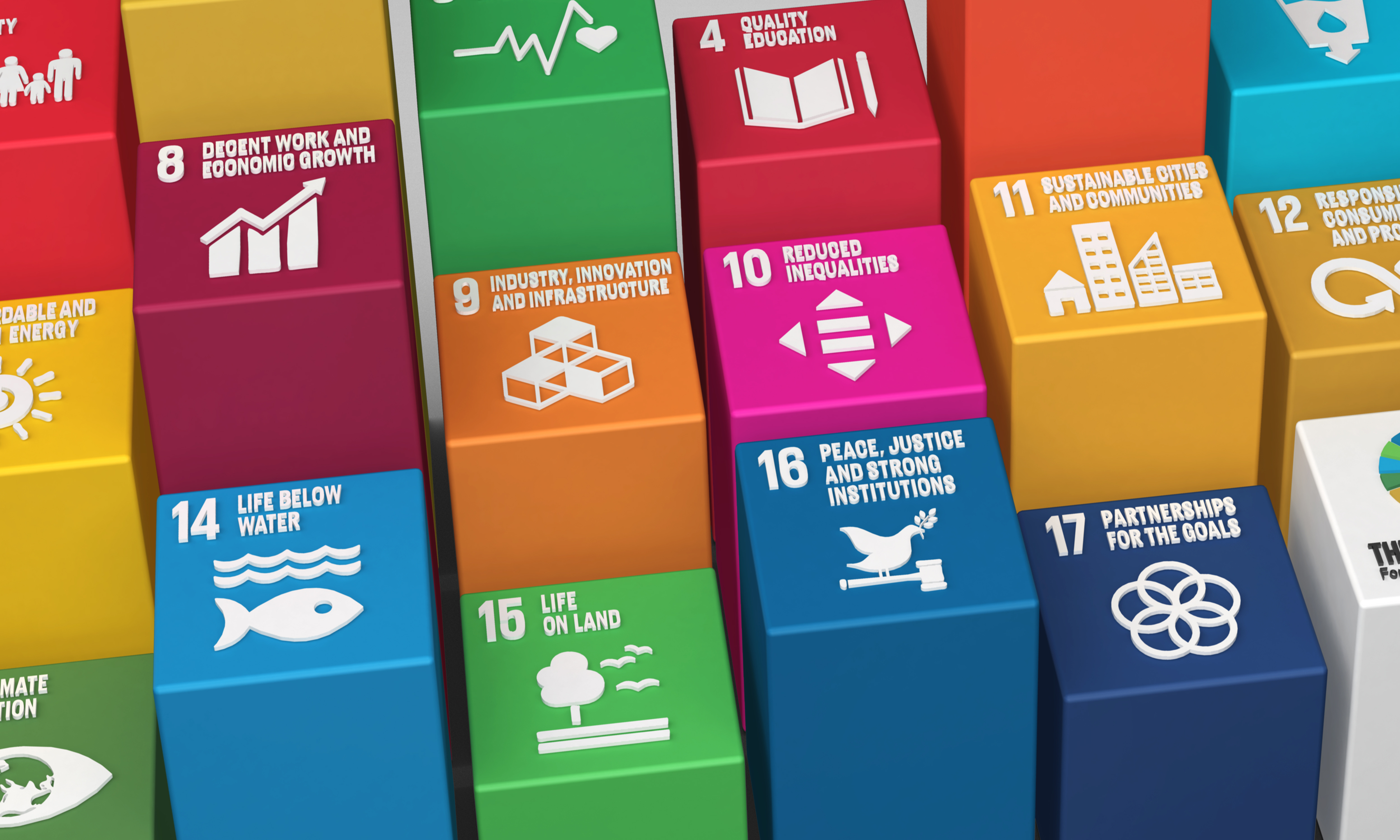 Des cubes colorés représentant les objectifs de développement durable des Nations Unies, avec des icônes et du texte blanc sur chaque cube.